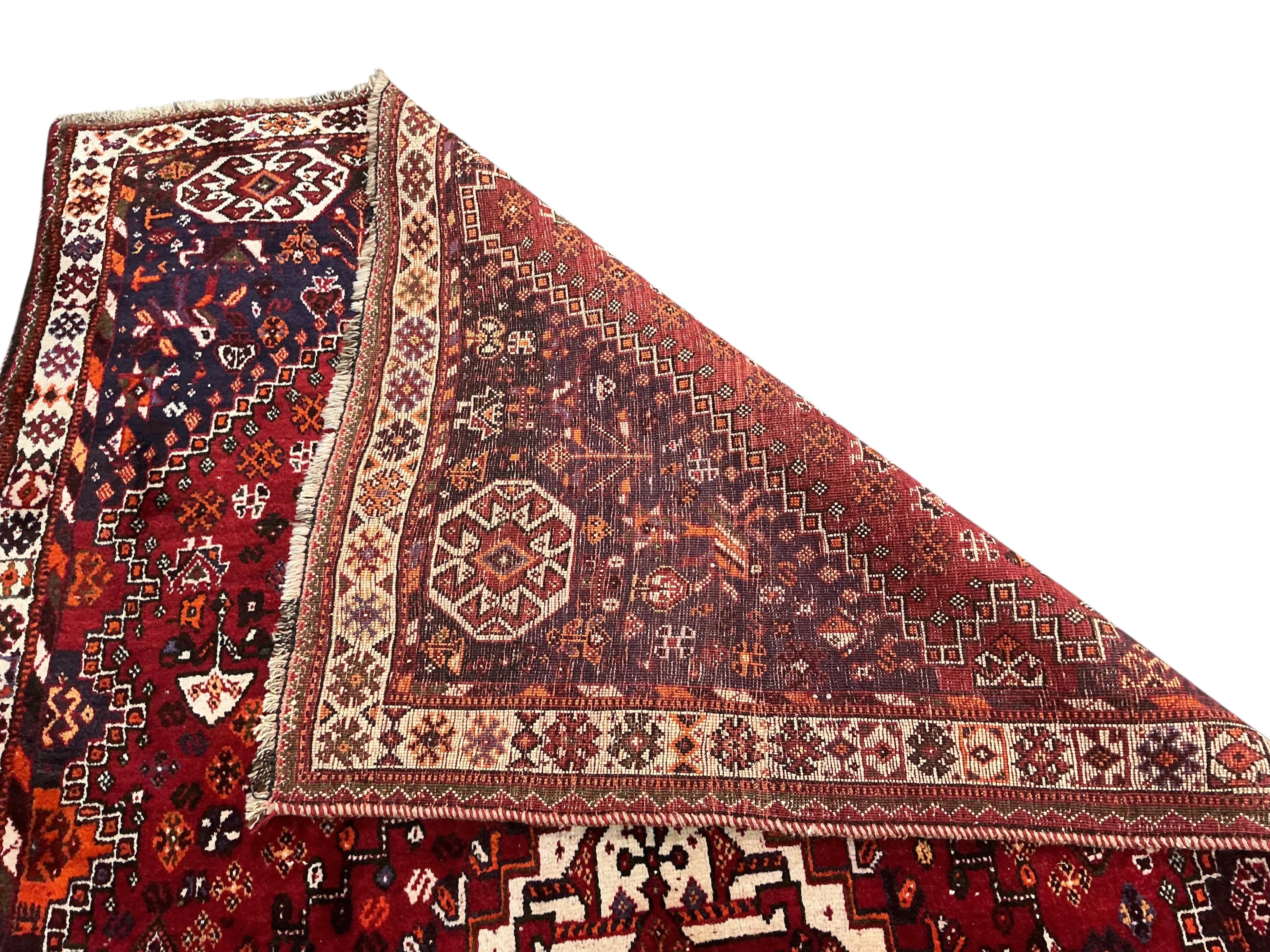 A Hamadan red ground rug 255 x 162cm